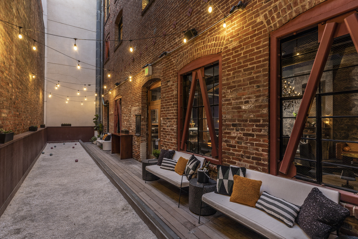 An outside area where you can play Bocce with nice outdoor lights