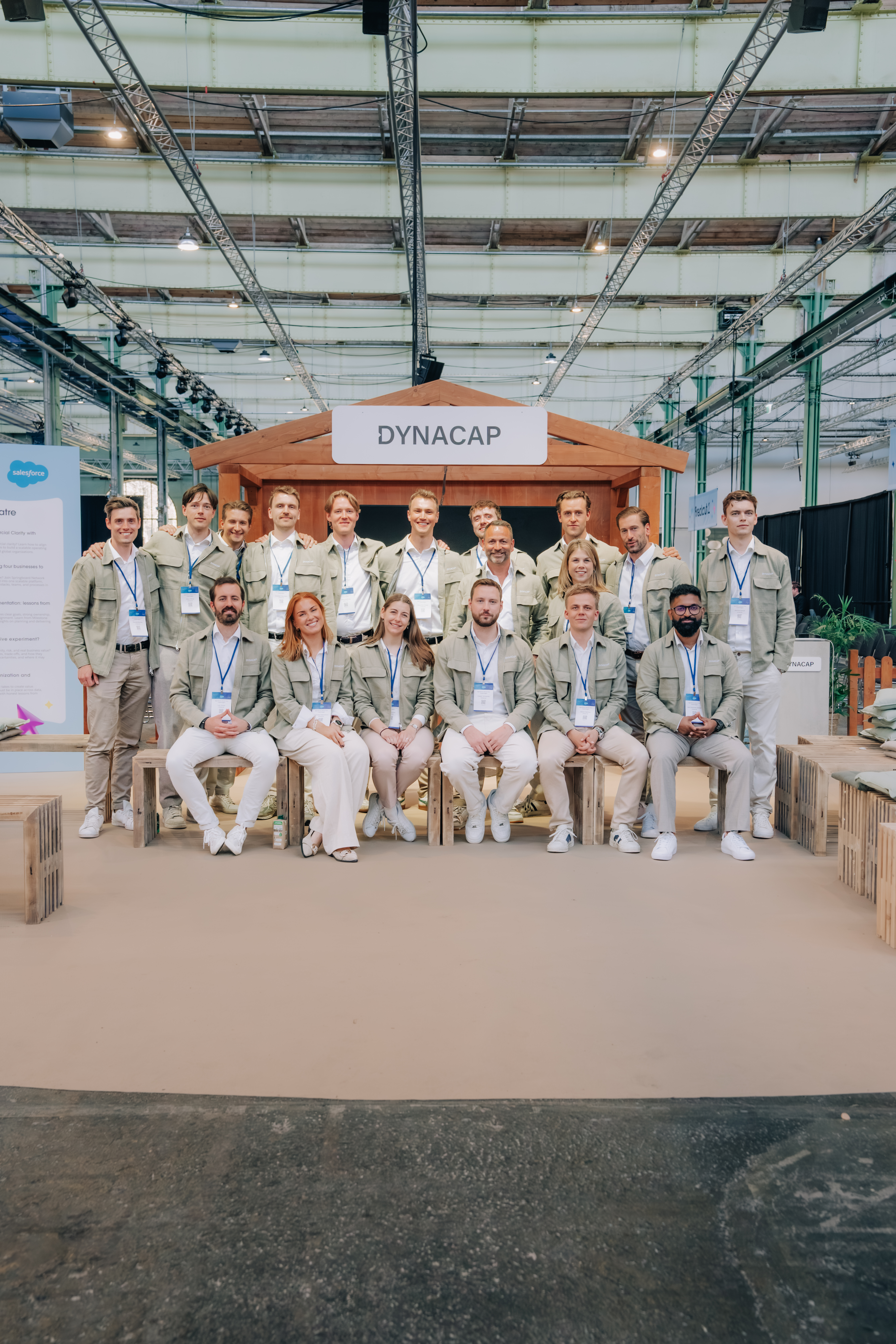 A group of people in green overshirts in front of a breakout area at Salesforce World Tour Copenhagen.